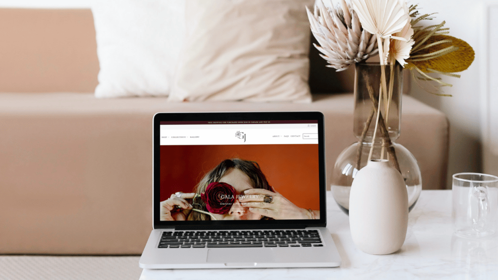 Laptop sitting open on a desk with Gala Jewelry website loaded