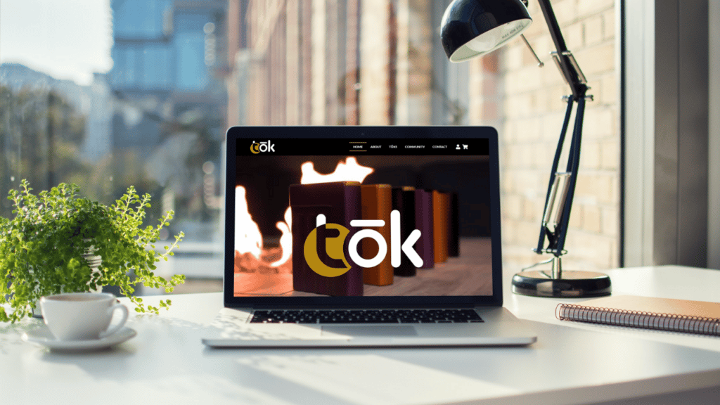 Laptop sitting open on a desk with The Tok Case website loaded